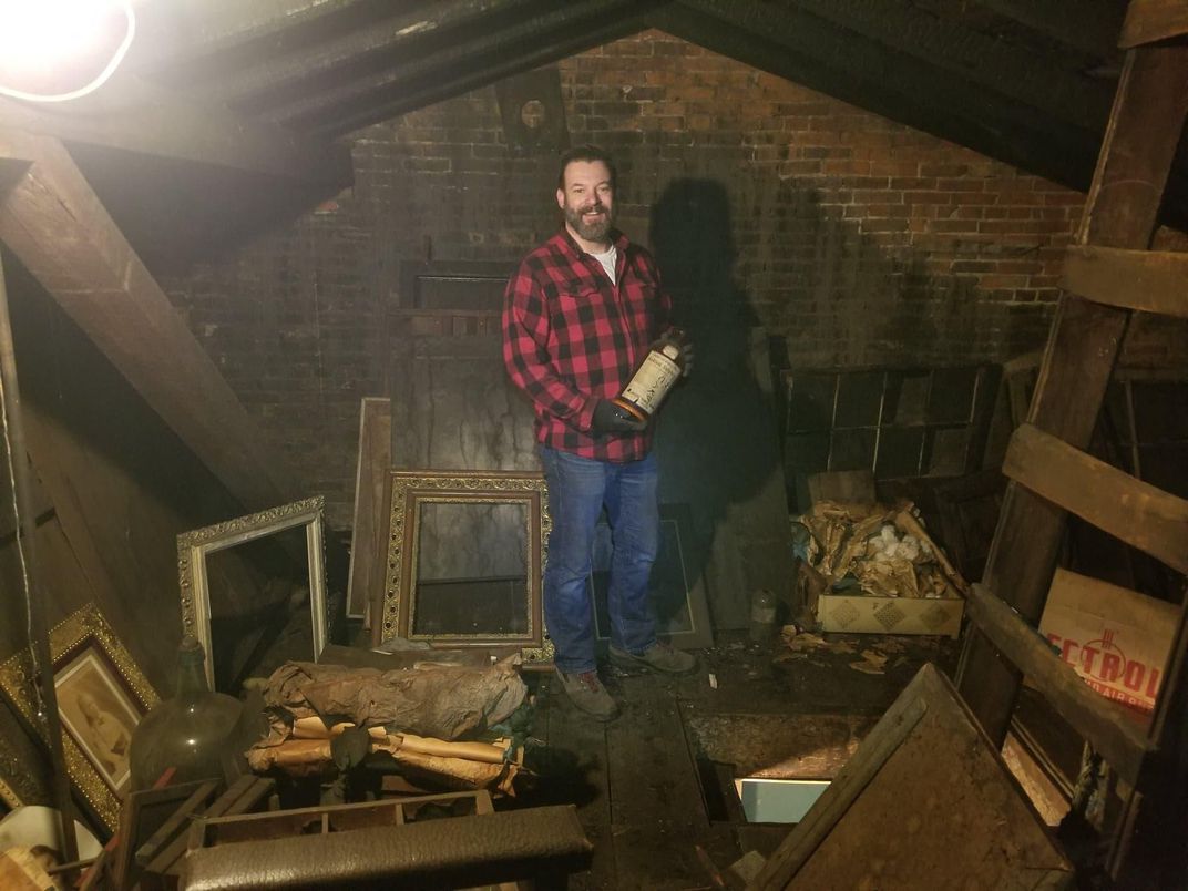 Lawyer David J. Whitcomb with the photographs he found in a secret attic in a building he purchased in Geneva, New York. Photo courtesy of David J. Whitcomb.