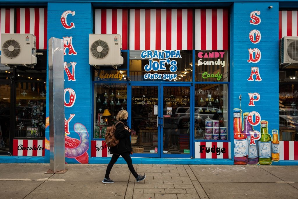 A passerby walks by a monolith outside of Grandpa Joes Candy Shop in the Strip District area of Pittsburgh, Pennsylvania on December 6, 2020. Photo by Maranie R. Staab/AFP via Getty Images.