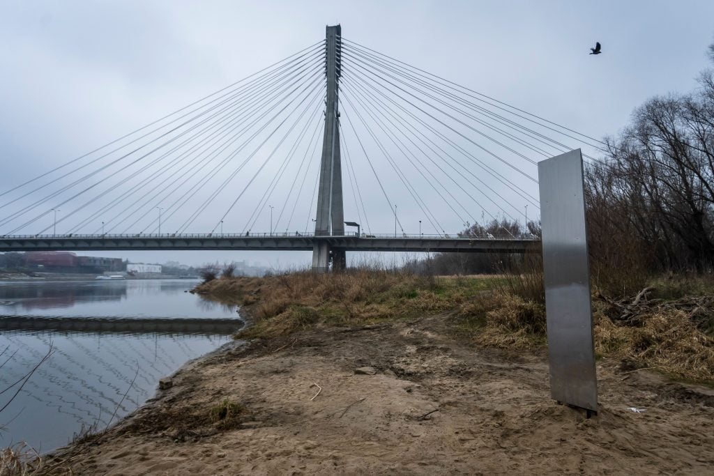 A metal monolith that has popped up on a riverbank of the Vistula in the Polish capital Warsaw, the latest in a string of similar objects that have recently appeared in Europe and the US, seen here on December 10, 2020. Photo by Wojtek Radwanski/AFP via Getty Images.
