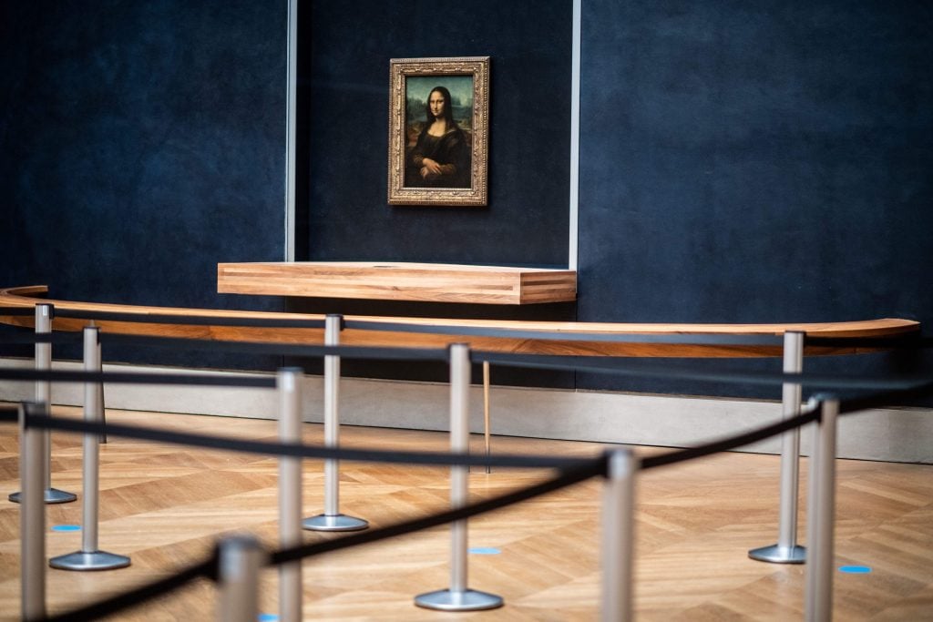 The Mona Lisa is displayed in the empty "Salle des Etats" of the Louvre Museum in Paris. Photo by MARTIN BUREAU/AFP via Getty Images.
