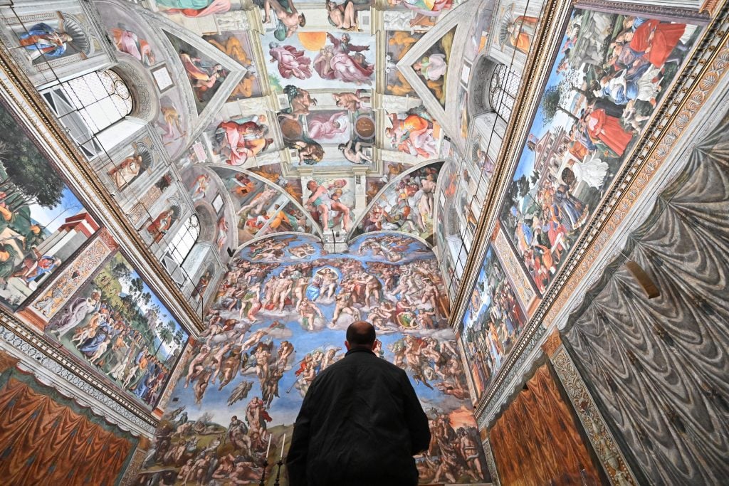 A man visits the Sistine Chapel on the reopening day of the Vatican museum on February 1, 2021. Photo by Andreas Solaro/AFP via Getty Images.