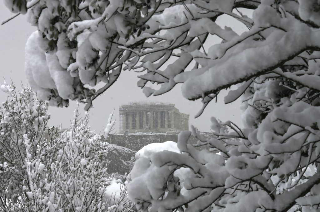 The Parthenon temple atop the Athenian Acropolis hill is pictured during heavy snowfalls in Athens on February 16, 2021. (Photo by ARIS MESSINIS/AFP via Getty Images)