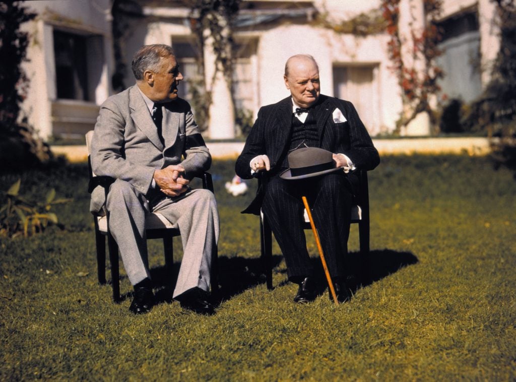 President Franklin D. Roosevelt and Prime Minister Winston Churchill talk on the lawn of the President's villa during the Casablanca conference. Bettmann / Contributor via Getty Images.