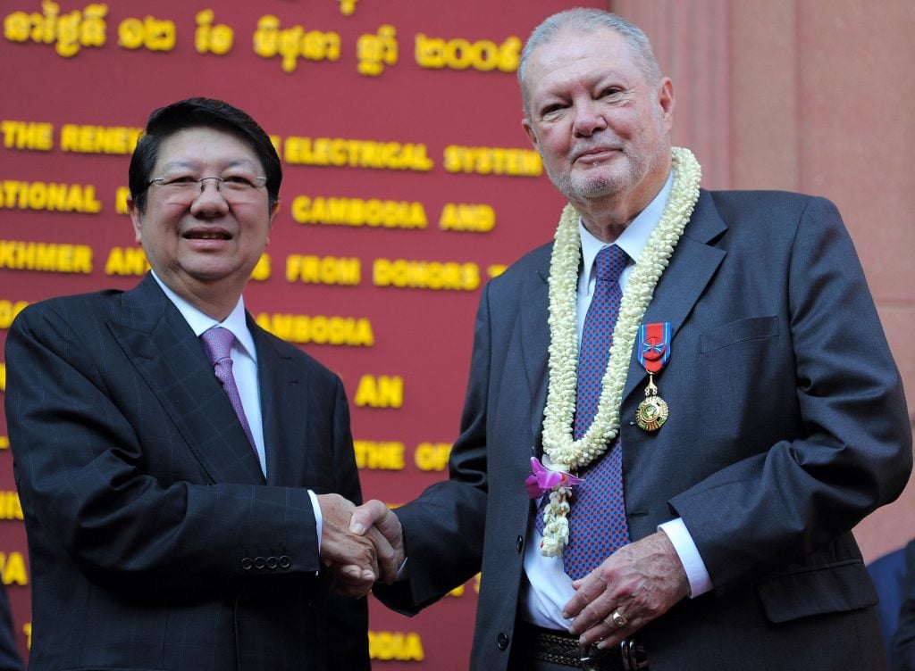 Cambodian deputy Prime Minister Sok An shakes hands with British Khmer art collector Douglas Latchford during a function at the National Museum of Cambodia in Phnom Penh on June 12, 2009. Latchford, a well known collector of Khmer art repatriated a number of Khmer antiquities during the event. Photo credit should read Tang Chhin Sothy/AFP via Getty Images.