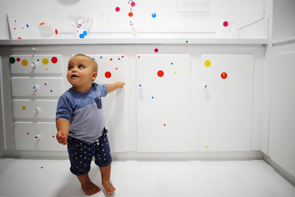 A boy in Yayoi Kusama's "obliteration room" at Auckland Art Galley. Photo by Hannah Peters/Getty Images.