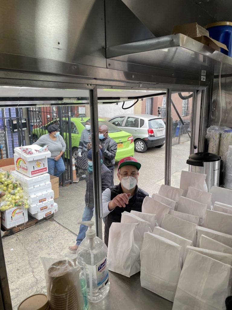 Distributing food at the Wide Awakes Mobile Soup Kitchen. Photo courtesy of the Wide Awakes Mobile Soup Kitchen. 