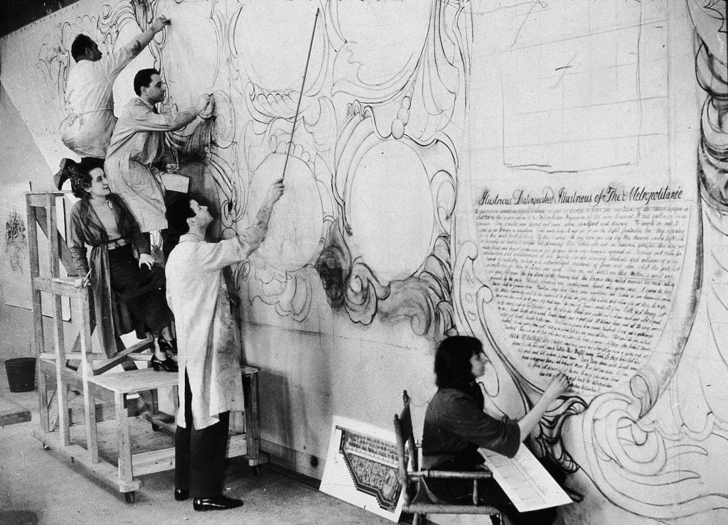 American artist Allen Saalburg directs WPA artists at work in a temporary studio at the American Museum of Natural History on murals commissioned for the Arsenal Building in Central Park, New York, New York, 1935. (Photo by New York Times Co./Getty Images