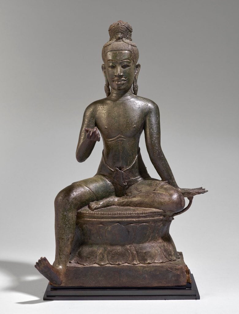 A bronze seated male deity from around the 11th century from Douglas Latchford's collection being repatriated to Cambodia. Photo by Matthew Hollow, courtesy of the Royal Government of Cambodia. 
