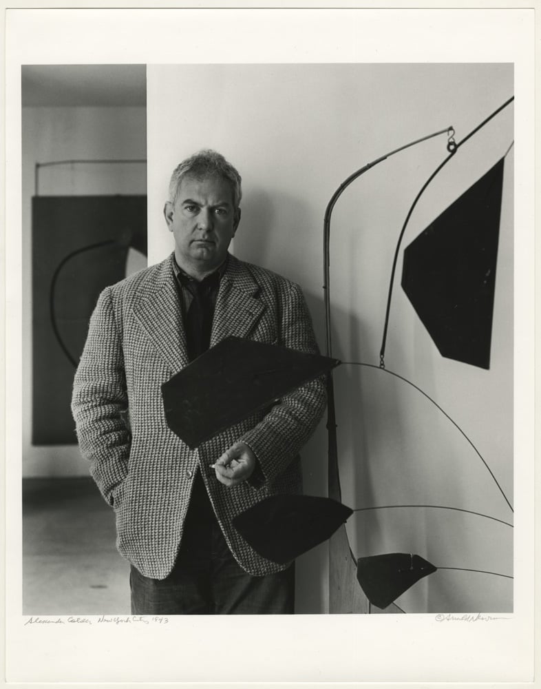 Calder at "Alexander Calder: Sculptures and Constructions," The Museum of Modern Art, New York, 20 September 1943. Photograph: Arnold Newman © Arnold Newman. © 2021 Calder Foundation, New York / Artists Rights Society (ARS), New York.