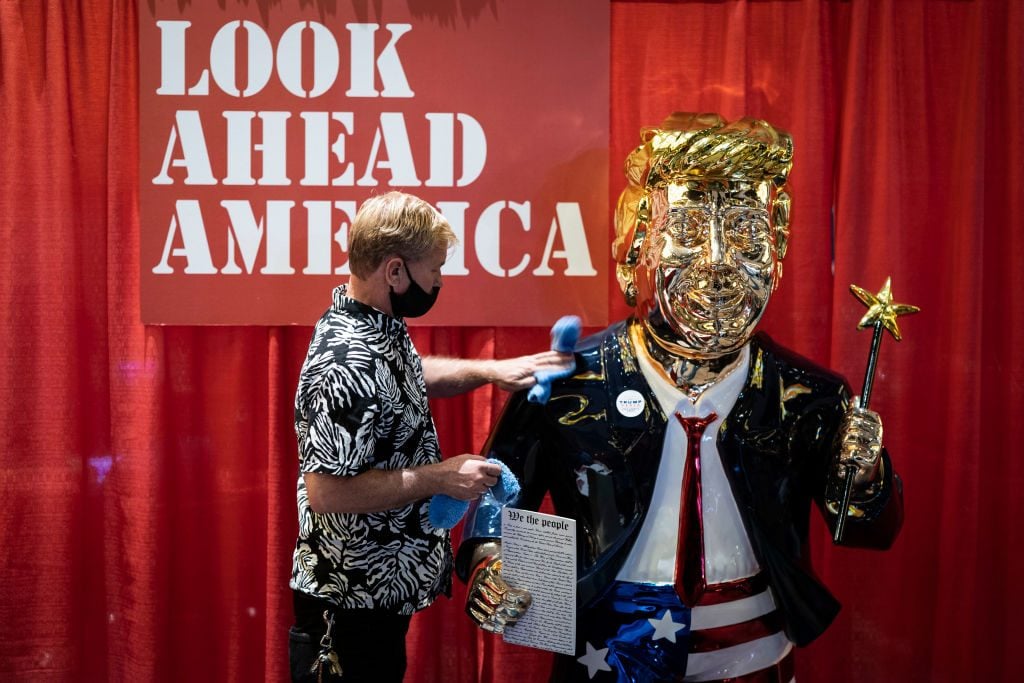 Artist Tommy Zegan cleans his statue of President Donald J. Trump during the Conservative Political Action Conference CPAC held at the Hyatt Regency Orlando on Friday, Feb 26, 2021 in Orlando, Florida. Photo by Jabin Botsford/The Washington Post via Getty Images.