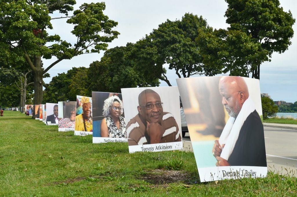 Images of COVID-19 victims from Detroit are displayed in a drive-by memorial at Belle Isle State Park on September 2, 2020 in Detroit, Michigan. Photo by Aaron J. Thornton/Getty Images.