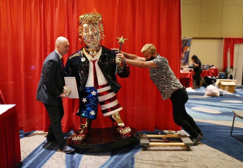 Matt Braynard (L) helps artist Tommy Zegan (R) move his statue of former President Donald Trump during the Conservative Political Action Conference on February 27, 2021 in Orlando, Florida. (Photo by Joe Raedle/Getty Images)
