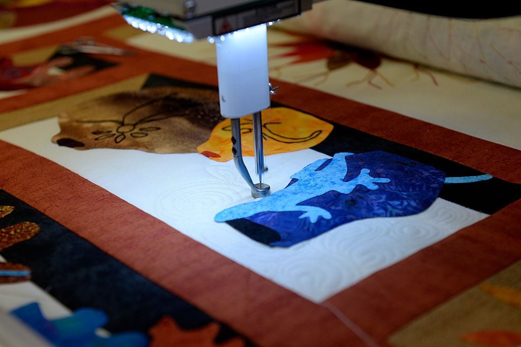 A quilter at work. Photo by Seth McConnell/The Denver Post via Getty Images.