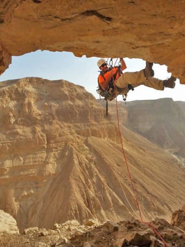 Rappelling to the Cave of Horrors. Photo by Eitan Klein, courtesy of the Israel Antiquities Authority.
