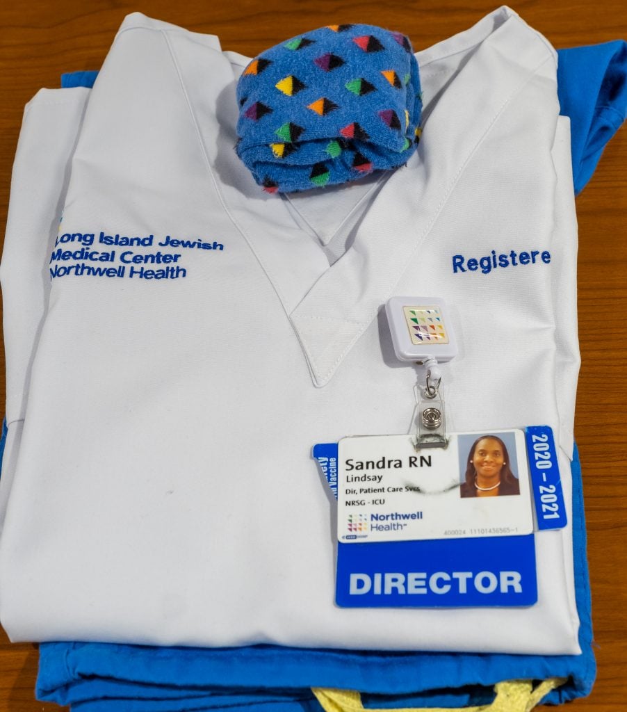 Scrubs and Staff ID badge belonging to Sandra Lindsay, an ICU nurse at Long Island Jewish Medical Center in New York, who was the first person known to receive the vaccine in the US. Photo courtesy of Northwell Health.