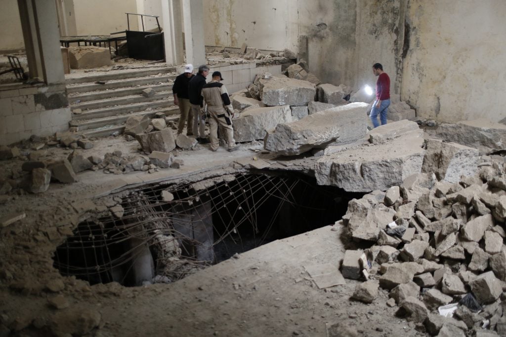 A joint Iraqi-Smithsonian team works to document the damage in the Mosul Cultural Museum’s Assyrian Hall in February 2019. Photo courtesy of the Smithsonian Institution. 