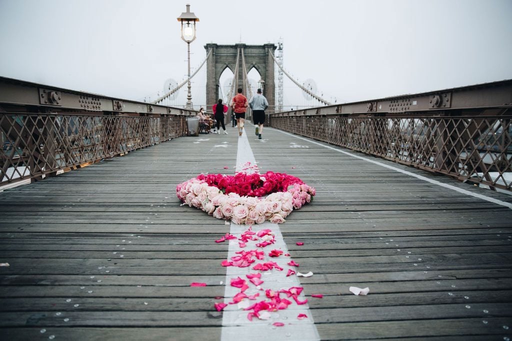 Kristina Libby, <em>The Floral Heart Project</em> on the Brooklyn Bridge. Photo by Erica Reade Images @ericareadeimages/Floral Heart Project @lightvslight.