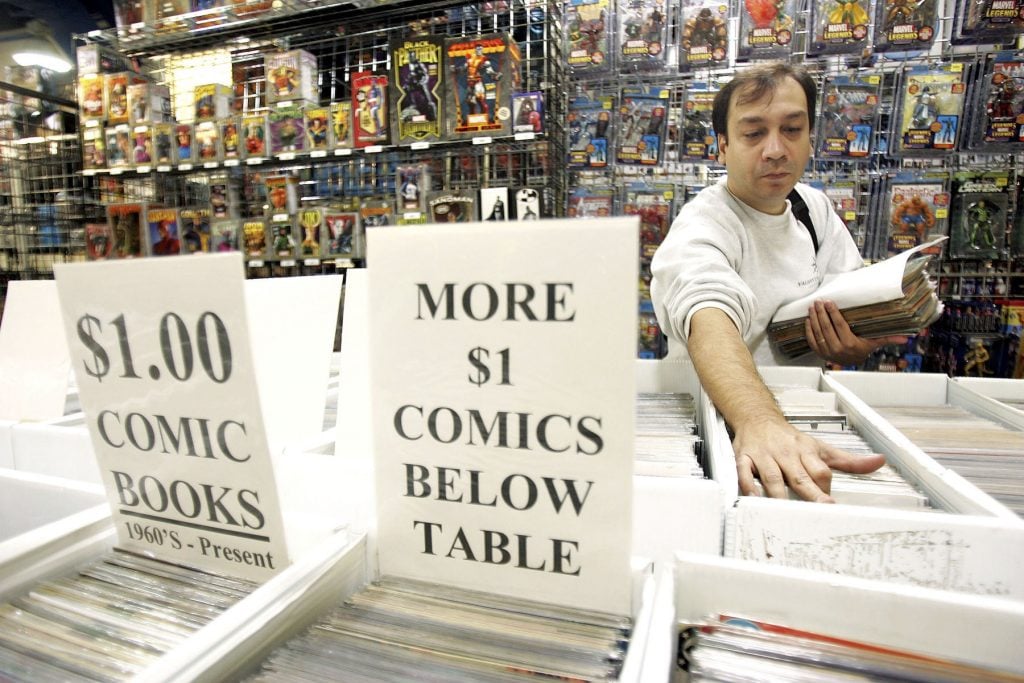 A comic book collector browses comics at the 10th Annual Big Apple National Comic Book, Toy & Sci-Fi Expo at Penn Plaza Pavillion November 18, 2005 in New York City. Photo by Scott Gries/Getty Images.
