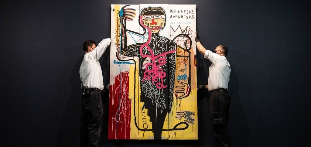 Art handlers with Basquiat's Versus Medici (1982). Courtesy of Sotheby's.