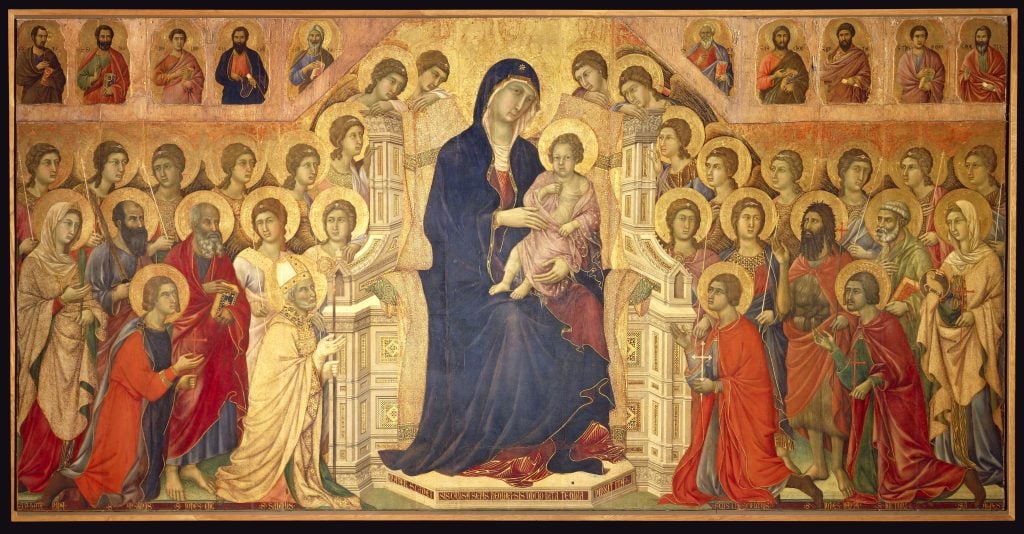 <em>Virgin Enthroned with Child, surrounded by Angels and Saints</em>, central panel of the <em>Maestà Altapiece</em> (1308-1311) by Duccio di Buoninsegna. Photo via Getty Images.