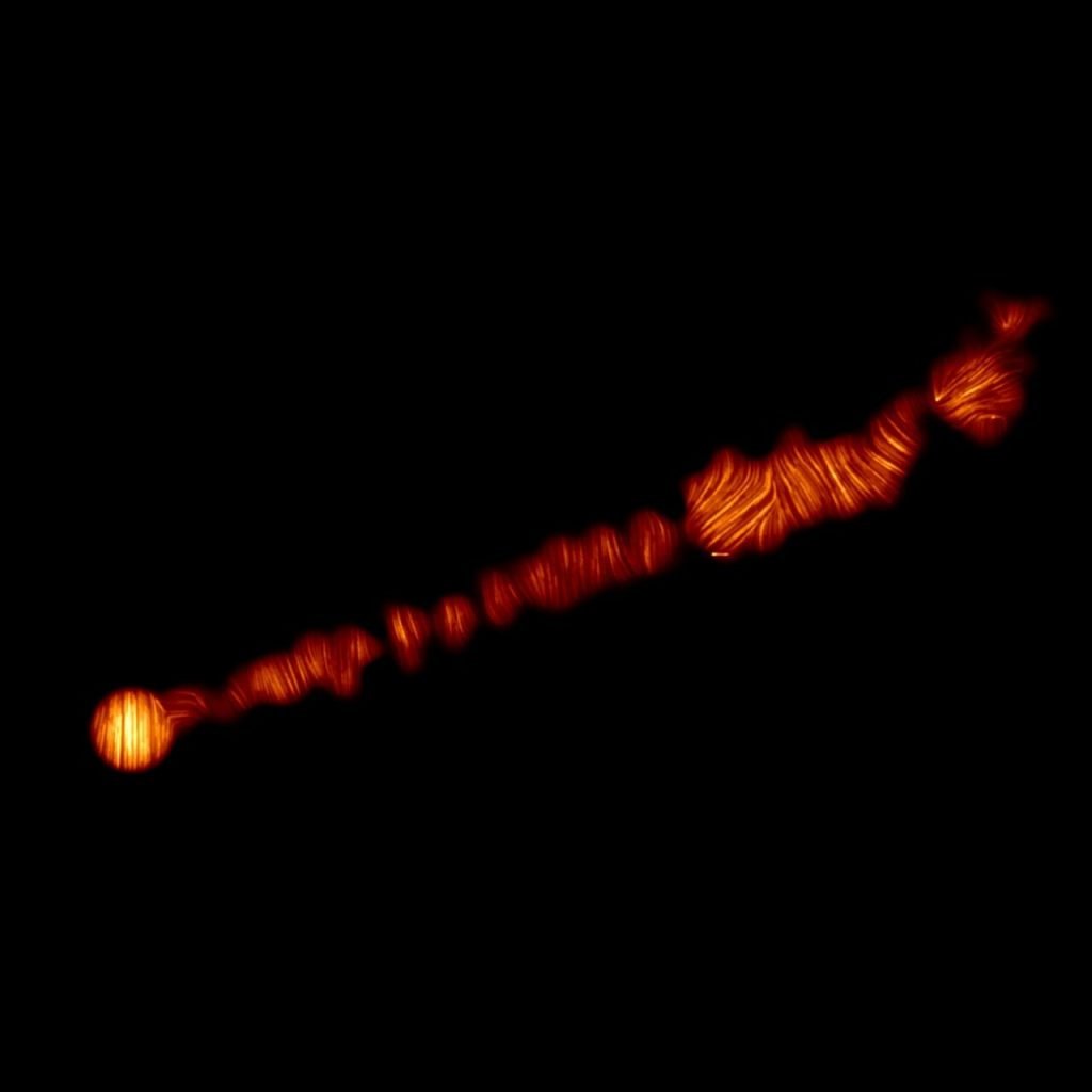 This image shows the jet in the M87 galaxy in polarized light. It is 6,000 light-years long. Image courtesy of ALMA (ESO/NAOJ/NRAO), Goddi et al.