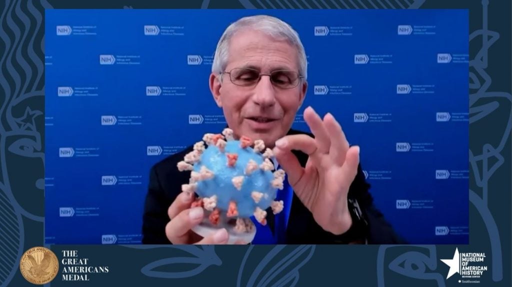 Anthony S. Fauci holds his personal 3D-printed model of the SARS-CoV-2 virion, which he is donating to the National Museum of American History, during the “Great Americans Awards Program.” Photo courtesy of the Smithsonian's National Museum of American History, Washington, DC.