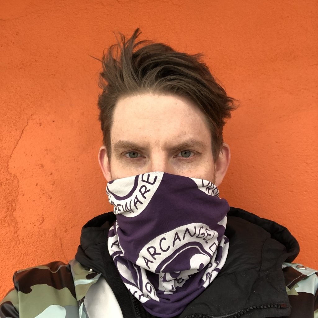 Cory Arcangel wearing an multi-function scarf from his clothing line, Arcangel Surfware. Courtesy of the artist