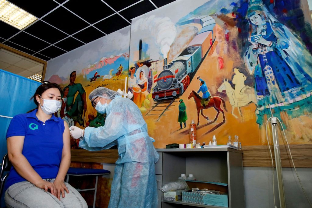 A woman receives a dose of the Sputnik V (Gam-COVID-Vac) vaccine against the coronavirus disease at a vaccination point in the Abylkhan Kasteyev State Museum of Arts of the Republic of Kazakhstan in Almaty on April 17, 2021. Photo by Ruslan Pryanikov/AFP via Getty Images.