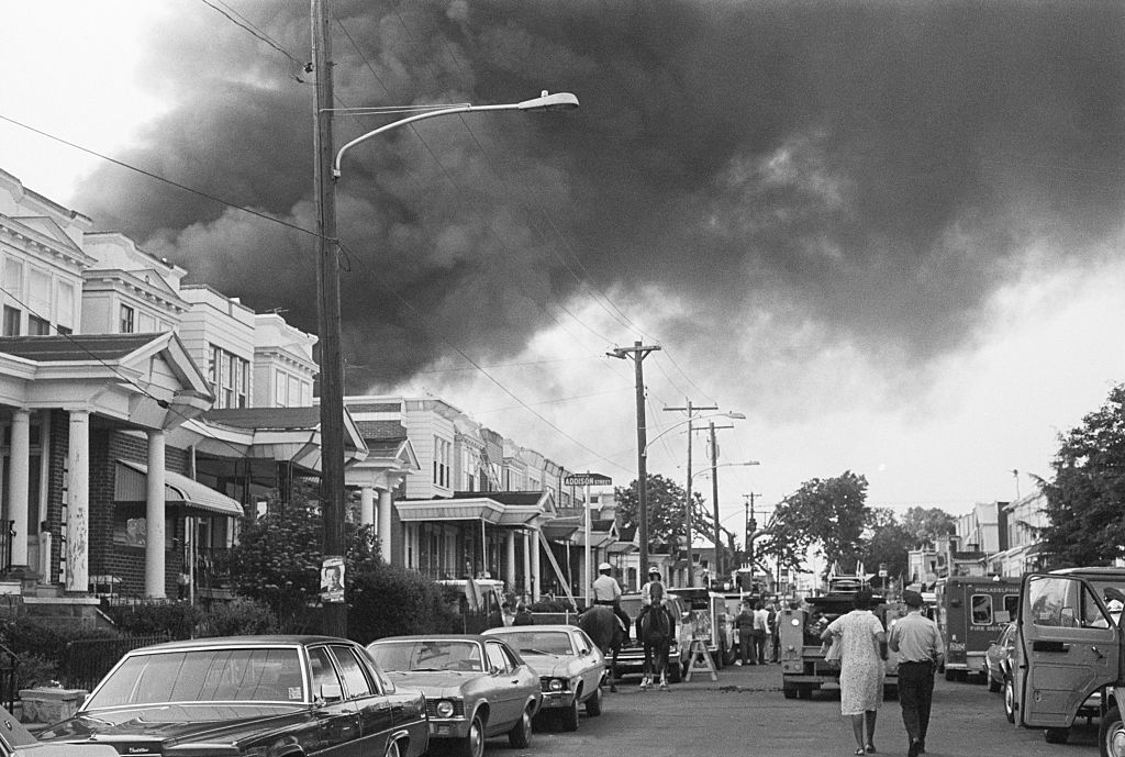 Smoke billows over rowhouses in the West Philadelphia after the police bombed the home of the radical African American organization MOVE during a standoff, via Getty Images.