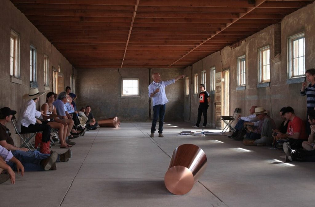 Rob Weiner giving a talk in the Roni Horn installation, “Things That Happen Again: For a Here and a There” during a Chinati Foundation Community Day in 2012. Photo courtesy of the Chinati Foundation.