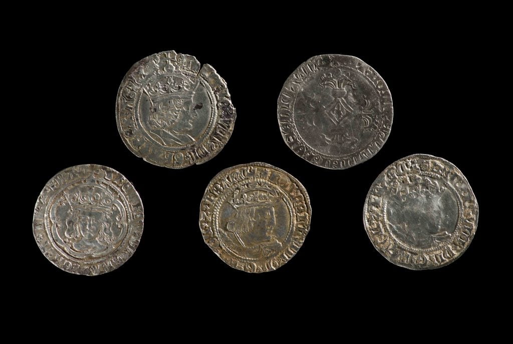Medieval coin hoard: 5 silver coins of Henry VII, Charles the Bold and Henry VIII. © Amgueddfa Cymru–National Museum Wales.