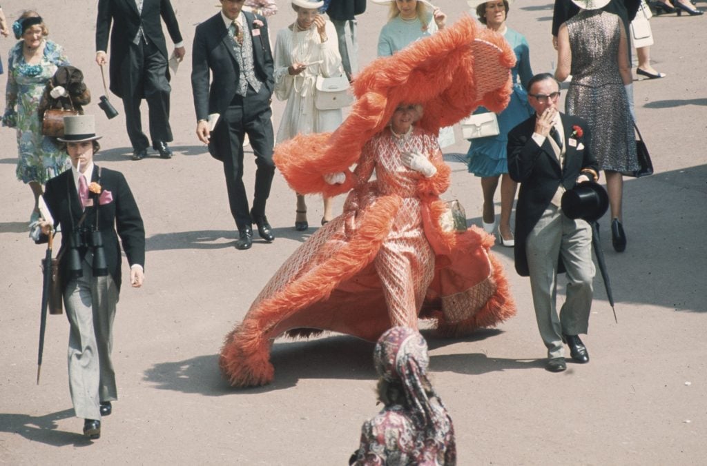 At Ascot Races, Gertrude Shilling appears in an apricot colored, feather trimmed outfit, which is completed by an enormous, matching, cartwheel hat, June 20, 1969. (Photo by Hulton Archive/Getty Images)