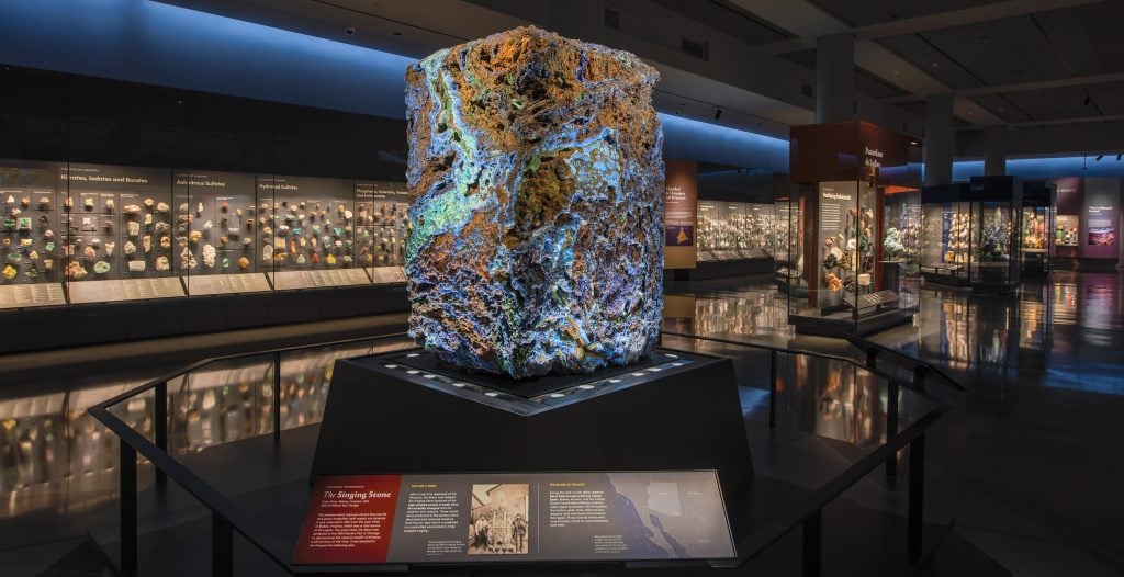 Known as the Singing Stone, this massive 4.5 ton block of vibrant blue azurite and green malachite from Arizona was first exhibited at the 1893 World’s Columbian Exposition in Chicago. After it was first displayed at the museum, this block was dubbed the Singing Stone because of the high-pitched sounds it made when the humidity changed with the weather and seasons. Now that it is exhibited in a controlled environment, it has stopped singing. Photo by D. Finnin, ©American Museum of Natural History.