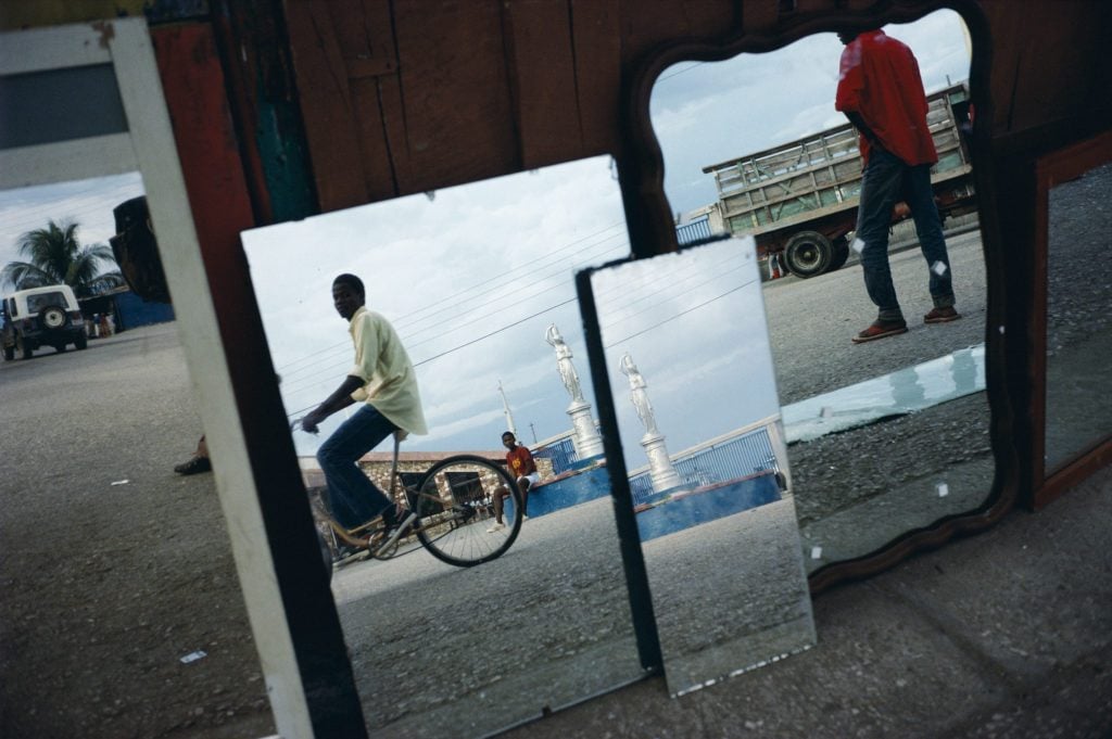 Alex Webb's Cap Haitien, Haiti, 1987 is among the pictures Dyer discusses in the new book. "Wherever he goes," Dyer writes, "Webb always ends up in a Bermuda-shaped triangle where the distinctions between photojournalism, documentary, and art blur and disappear." Dyer's writings similarly blur genres and collapse distinctions. Photo courtesy Graywolf Press.