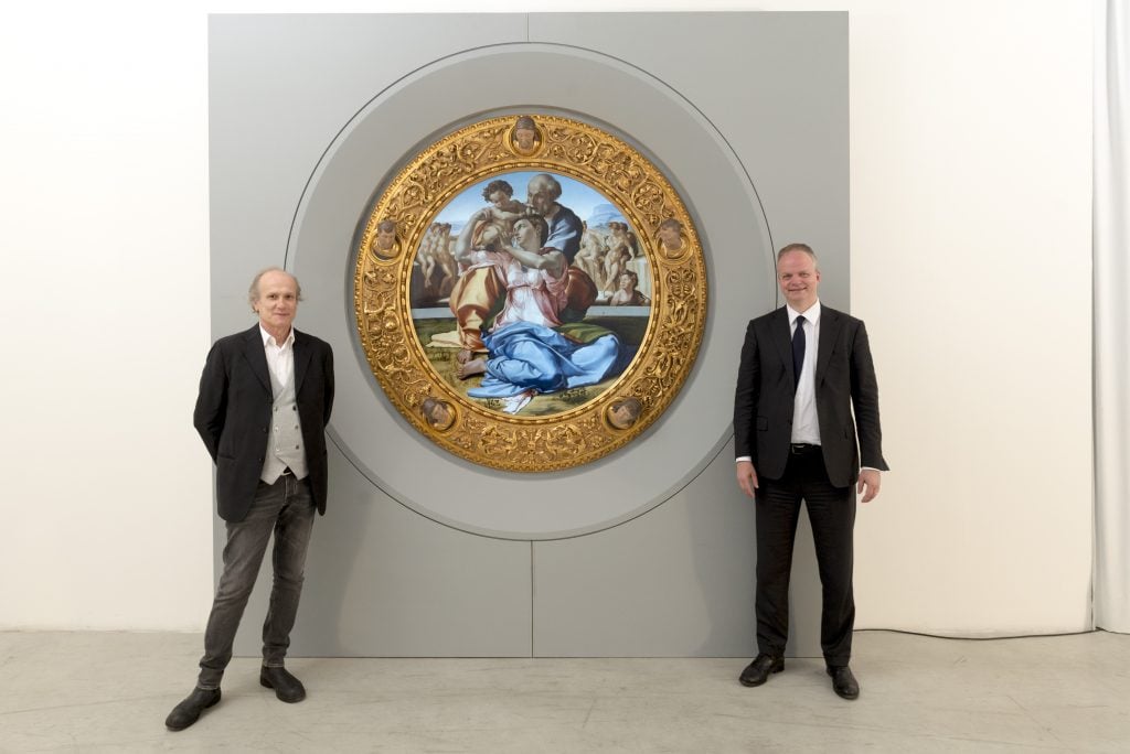 Cinello founder and CEO Franco Losi (L) and Uffizi director Eike Schmidt (R) with Michelangelo's <i>Doni Tondo</i> (1505-06).