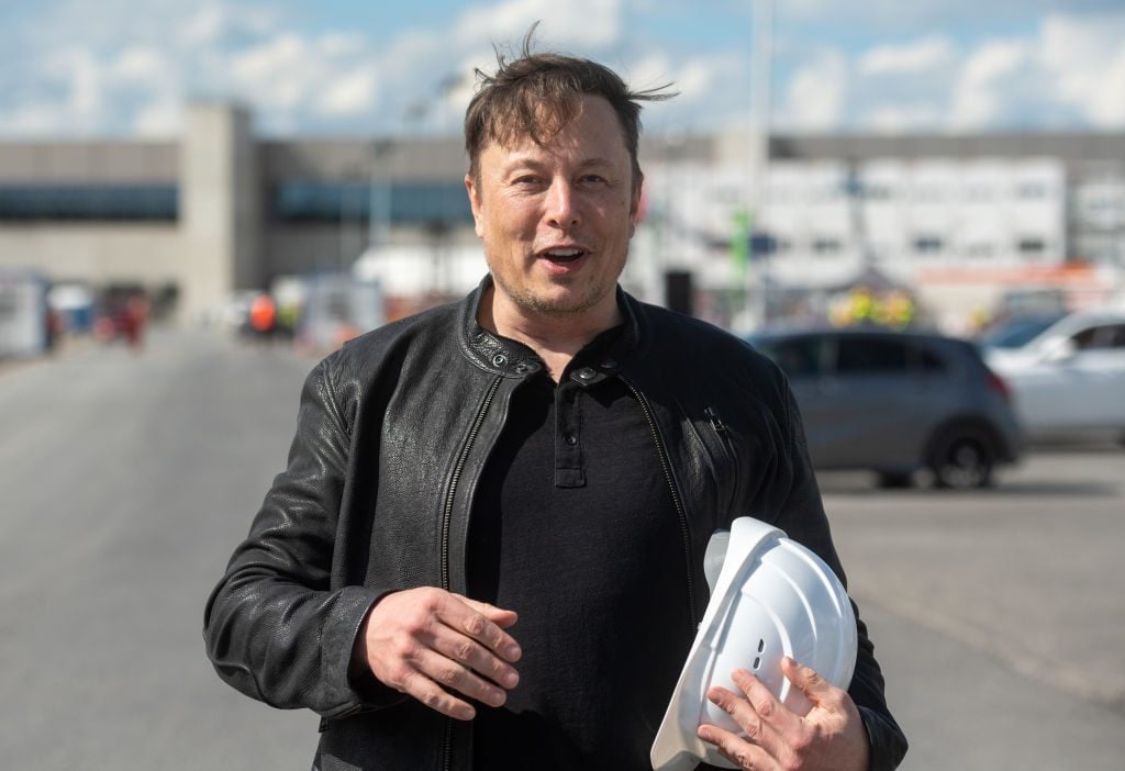 Elon Musk, Tesla CEO, stands on the construction site of the Tesla factory holding his hard hat.Photo by Christophe Gateau/picture alliance via Getty Images.