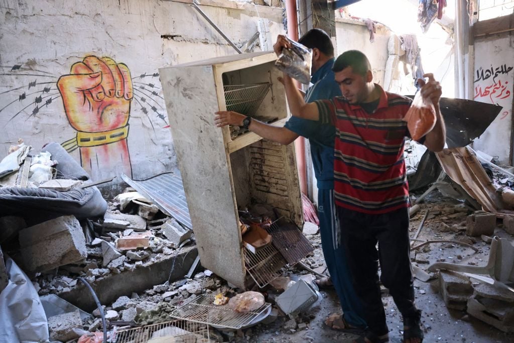 Palestinians check the aftermath of Israeli airstrikes in Rafah in the southern Gaza Strip on May 19, 2021. Photo by SAID KHATIB / AFP via Getty Images.