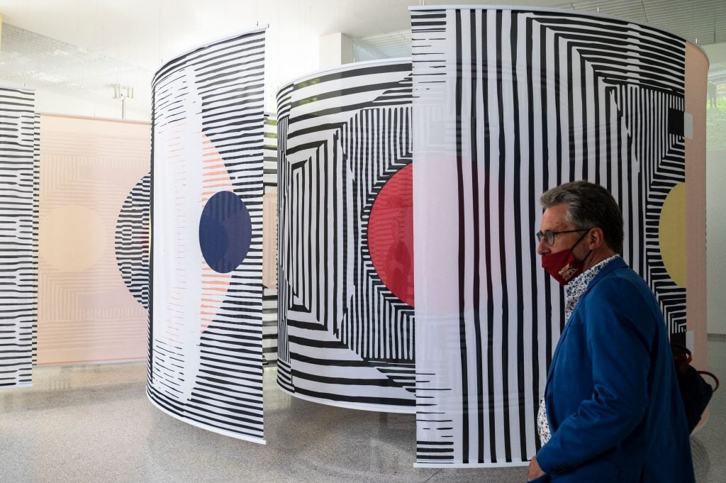 A visitor views "Why is We" by Afaina de Jong and Debra Solomon at the Dutch pavilion of the 17th Venice Architecture Biennale in Venice on May 19, 2021. Photo by Marco Bertorello/AFP via Getty Images.
