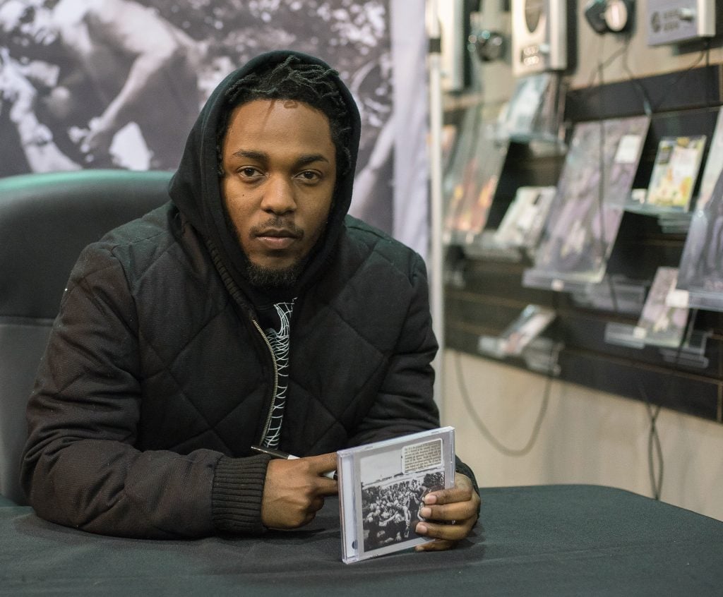 Kendrick Lamar signs copies of "To Pimp A Butterfly" at Rough Trade NYC in March 2015. (Photo by Mike Pont/Getty Images)