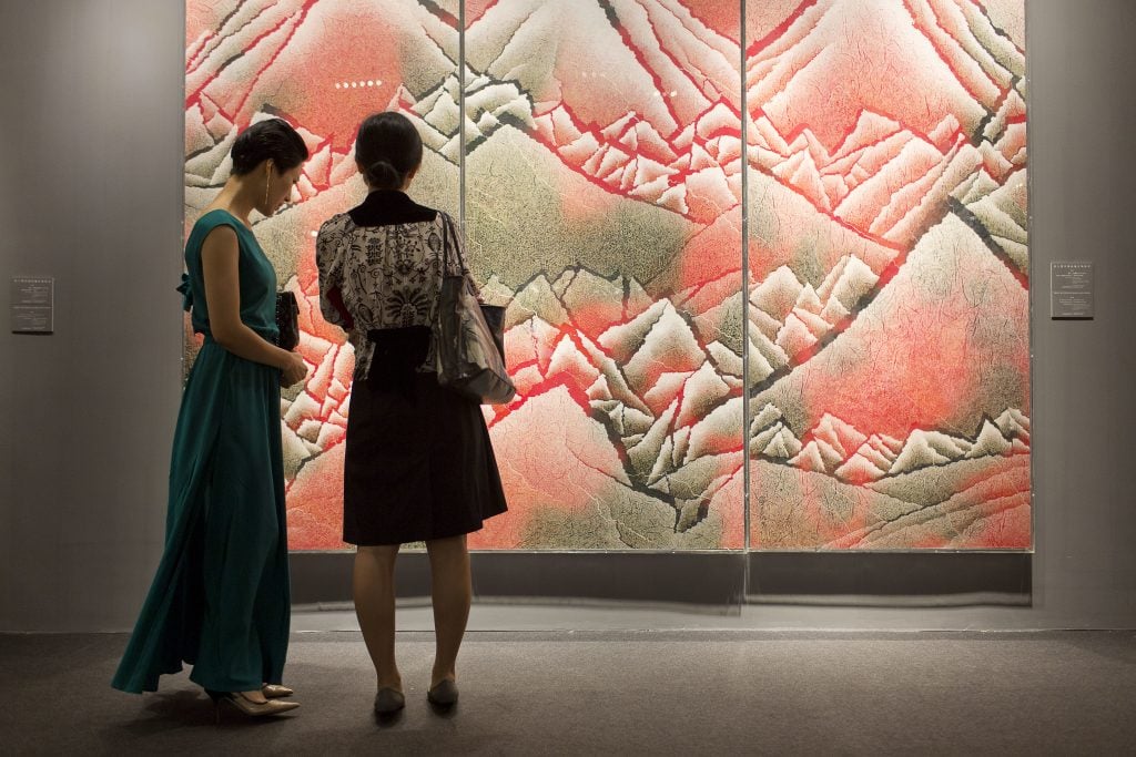 Visitors to an auction preview in Beijing. (Photo by In Pictures Ltd./Corbis via Getty Images)