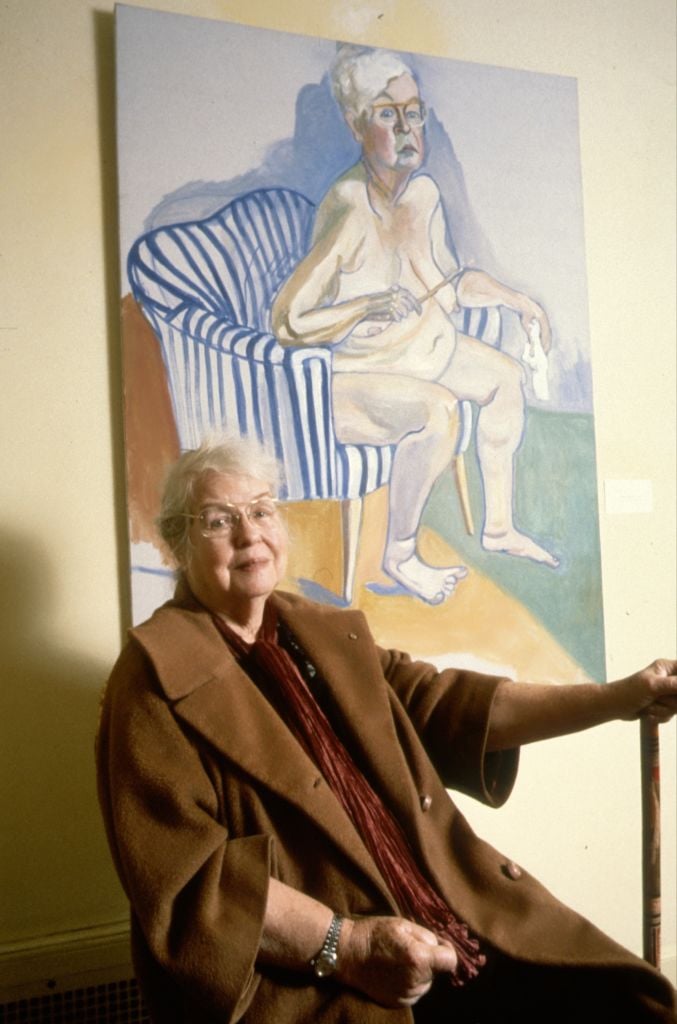 Artist Alice Neel, an elderly woman holding a cane, sitting next to her nude self-portrait