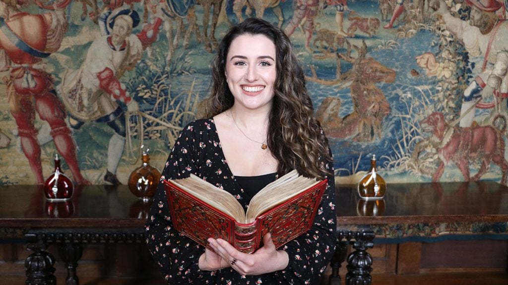 Kate McCaffrey with Anne Boleyn’s Book of Hours prayer book. Photo courtesy of Hever Castle & Garden.