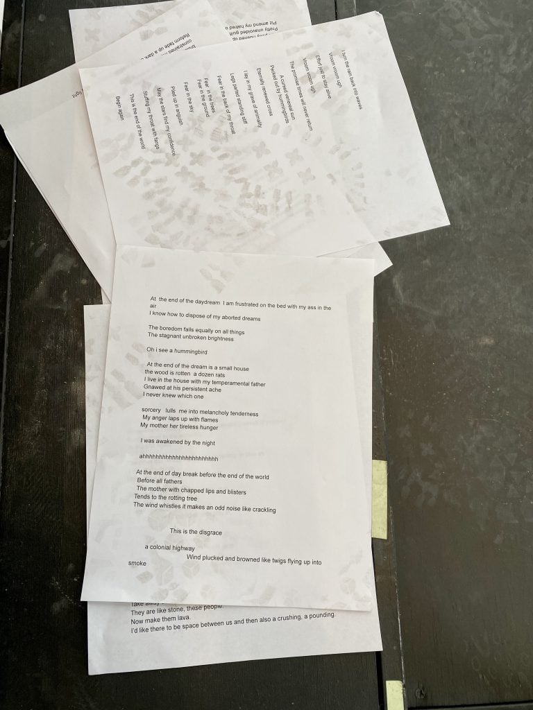 Pages from Precious Okoyomon's poem "Skysong," for the piece <em>This God Is a Slow Recovery</em>, Frieze Artist Award supported by the Luma Foundation, Frieze New York 2021. Photo by Sarah Cascone.