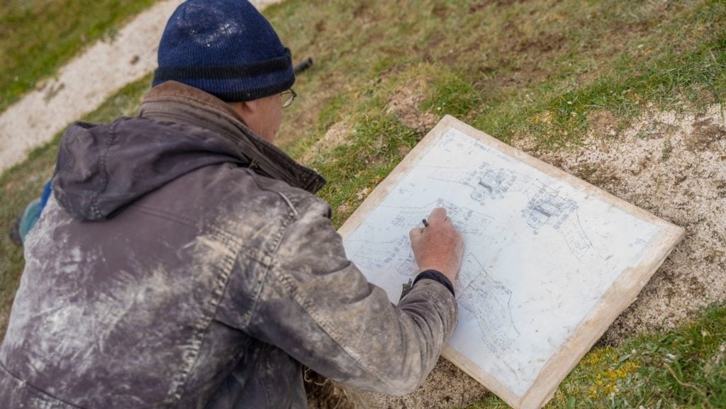 National Trust senior archaeologist Martin Papworth making site sketches during soil sampling at the Cerne Giant. Photo courtesy of the National Trust.