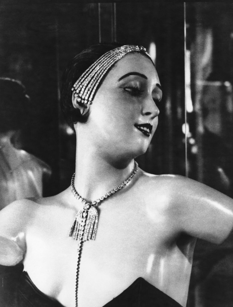 A wax mannequin wearing a necklace and jewelled headband designed by French fashion designer Coco Chanel, Paris, circa 1932. (Photo by Albert Harlingue/Roger Viollet via Getty Images)