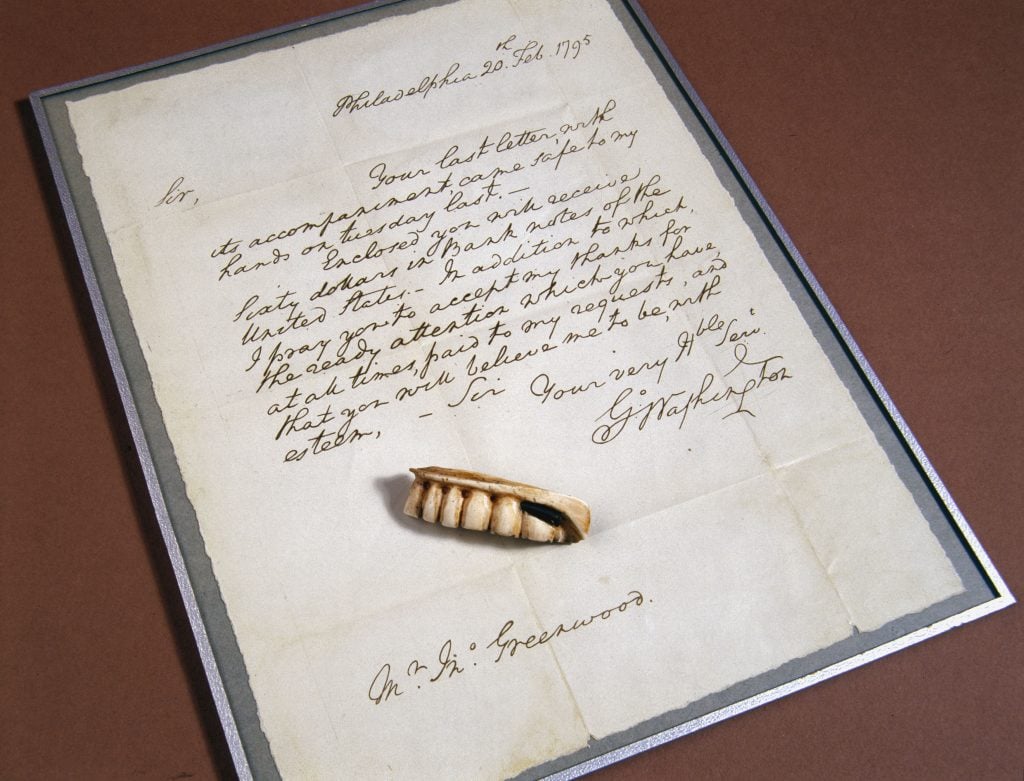 A replica set of George Washington's dentures with a copy of a letter of thanks the first President wrote to his dentist. The real dentures have a vastly more unsettling history than you were led to believe in elementary school. (Photo by SSPL/Getty Images)