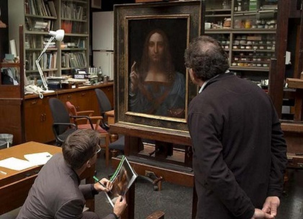 Robert Simon inspecting Salvator Mundi at the National Gallery, London, in 2011, as seen in The Lost Leonardo (2021), film still. Photo by Robert Simon, courtesy of Sony Pictures Classics.