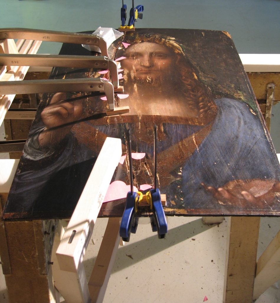 Restoring the crack on Salvator Mundi in 2006 as seen in The Lost Leonardo (2021), film still. Photo by Robert Simon, courtesy of Sony Pictures Classics.