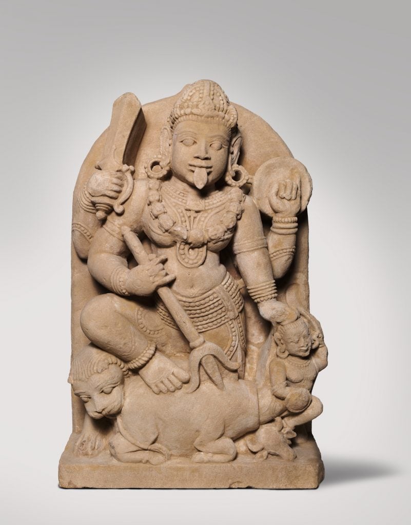 A 12th- or 13th-century stone sculpture depicting the goddess Durga slaying the buffalo demon. Courtesy of the NGA.