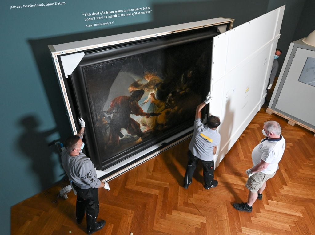 Employees of the international freight forwarder Hasenkamp pack the painting The Blinding of Samson (1636) by the Dutch master Rembrandt van Rijn. Photo: Arne Dedert/dpa/picture alliance via Getty Images.